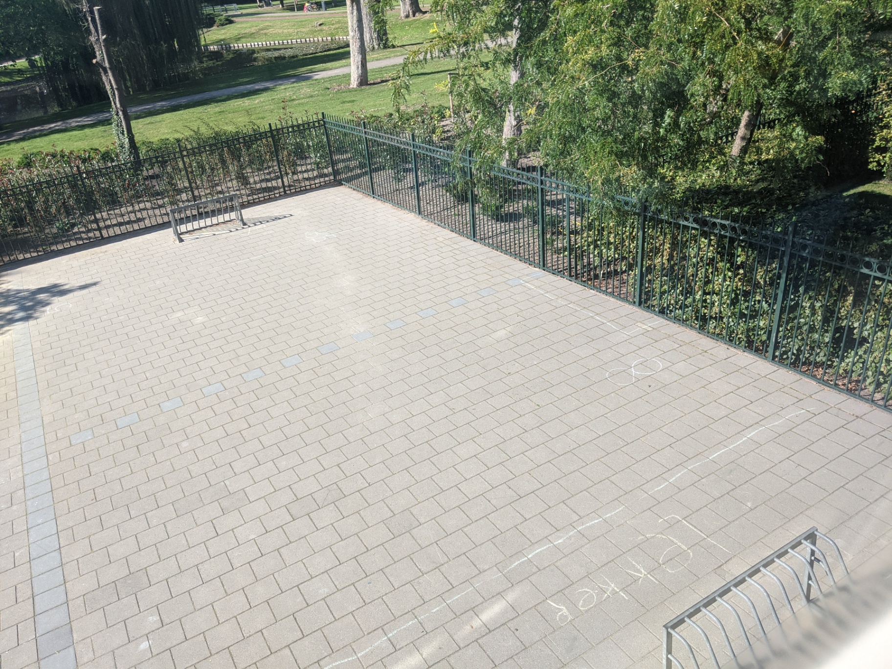 Een leeg, betegeld schoolplein zonder speelaanleidingen